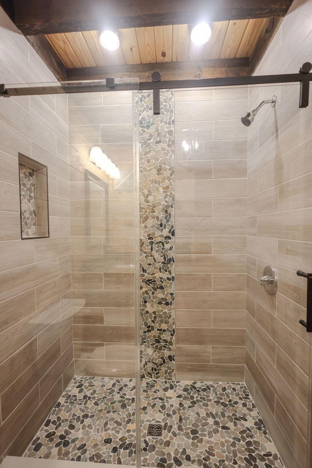 bathroom featuring wood ceiling and a shower stall