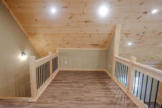 bonus room featuring lofted ceiling, wooden ceiling, and wood finished floors