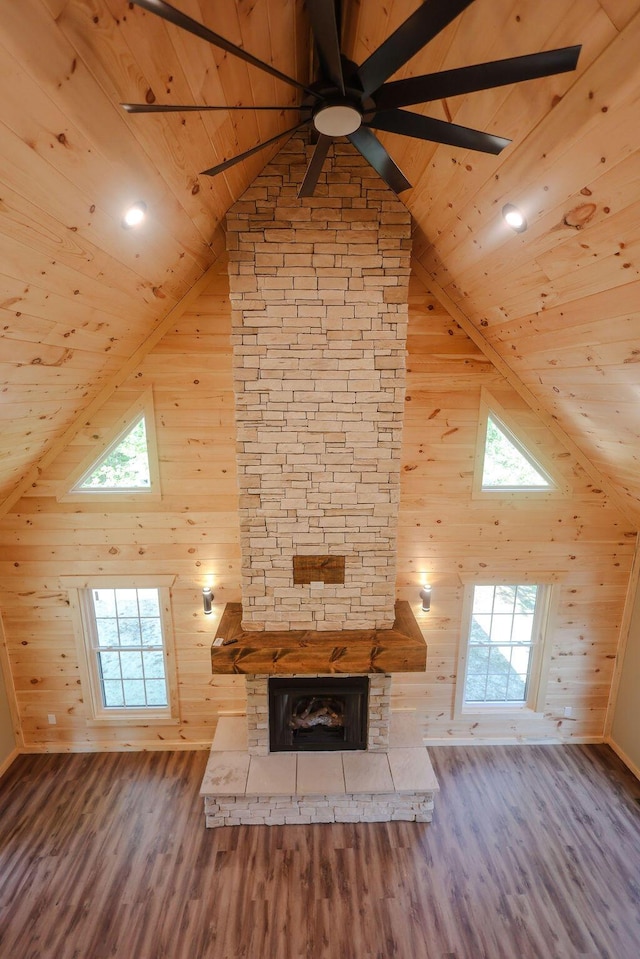 unfurnished living room featuring wooden ceiling, a fireplace, high vaulted ceiling, and wood finished floors