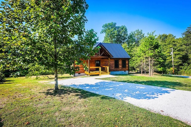 exterior space featuring covered porch and a yard