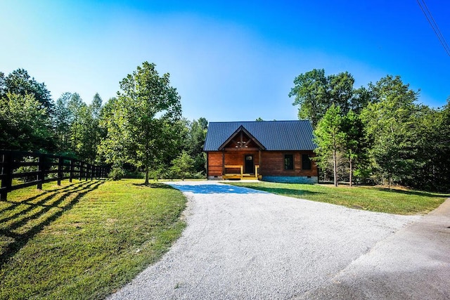 view of front of property featuring driveway, metal roof, crawl space, fence, and a front yard