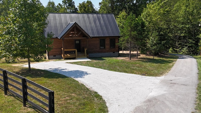 view of front of property featuring a porch, crawl space, fence, metal roof, and a front lawn