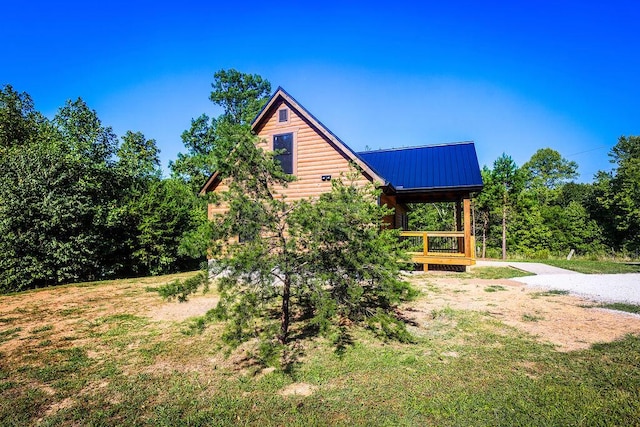 view of property exterior featuring metal roof