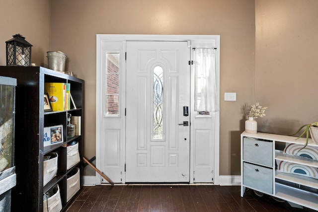 foyer with dark wood-style floors and baseboards