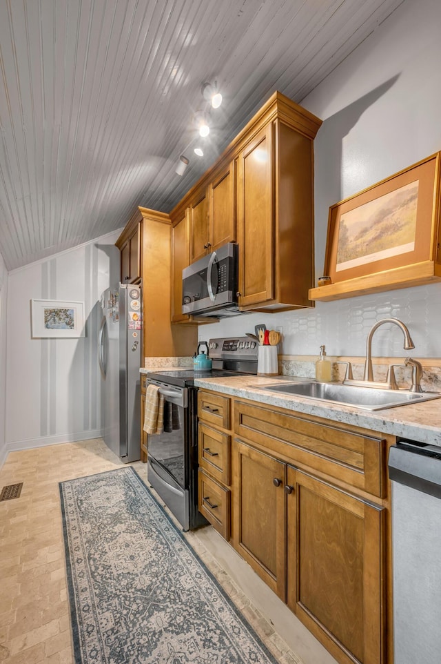 kitchen with wooden ceiling, a sink, light countertops, appliances with stainless steel finishes, and brown cabinets