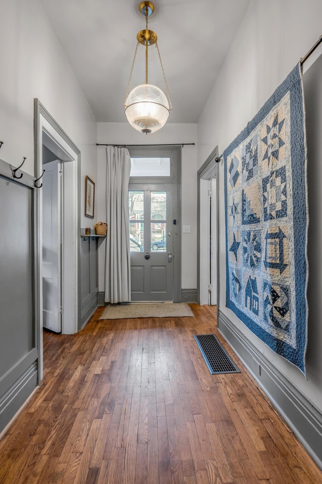 entryway with visible vents and hardwood / wood-style floors