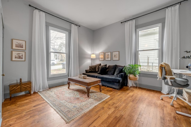 home office with baseboards, a wealth of natural light, and light wood-style floors