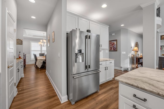 kitchen featuring recessed lighting, stainless steel fridge with ice dispenser, and wood finished floors