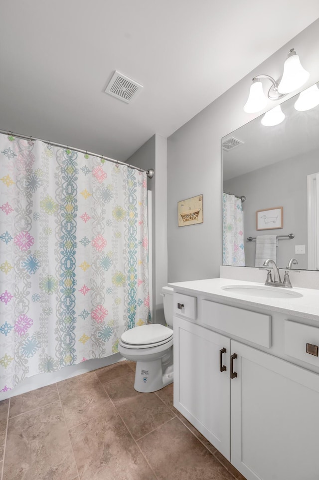 bathroom featuring toilet, tile patterned flooring, vanity, and visible vents