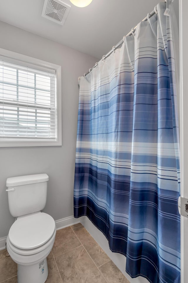 bathroom with toilet, tile patterned flooring, visible vents, and baseboards