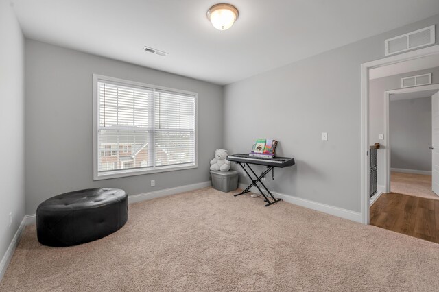 miscellaneous room featuring carpet floors, baseboards, and visible vents