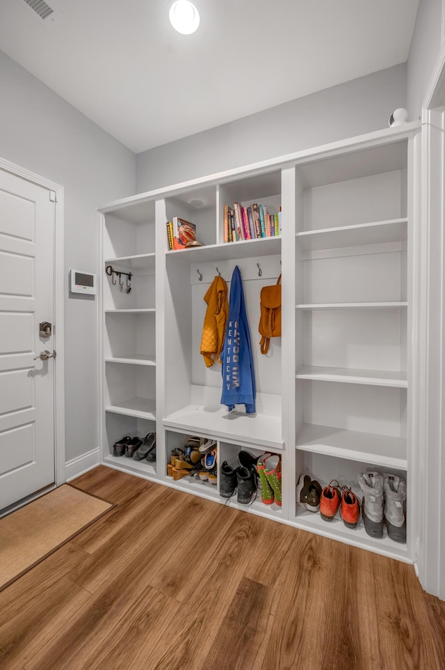 mudroom featuring baseboards and wood finished floors