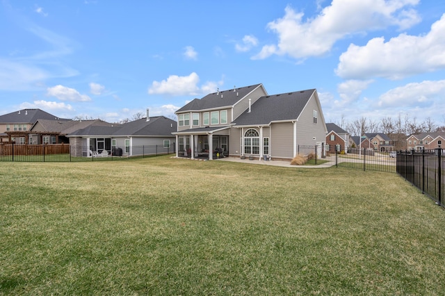 back of house featuring a patio, a lawn, a fenced backyard, and a residential view