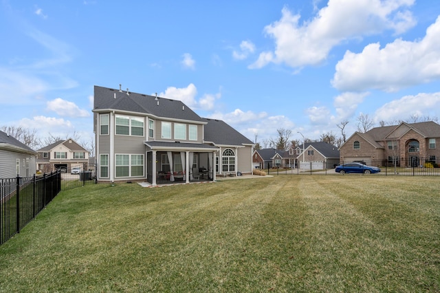 back of house with a patio area, a fenced backyard, a residential view, and a lawn