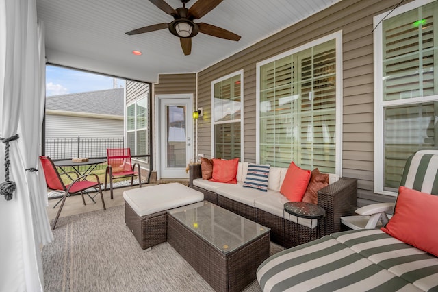 sunroom / solarium with a ceiling fan