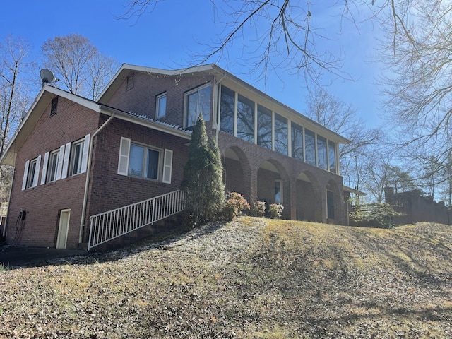 rear view of house with brick siding