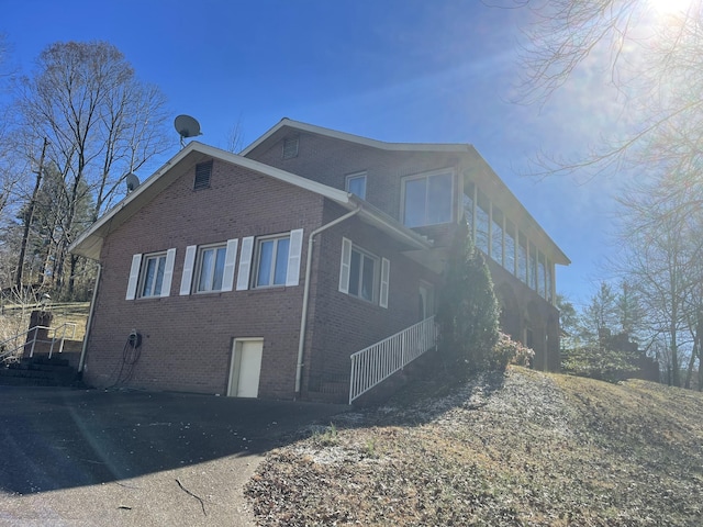 view of side of home with brick siding