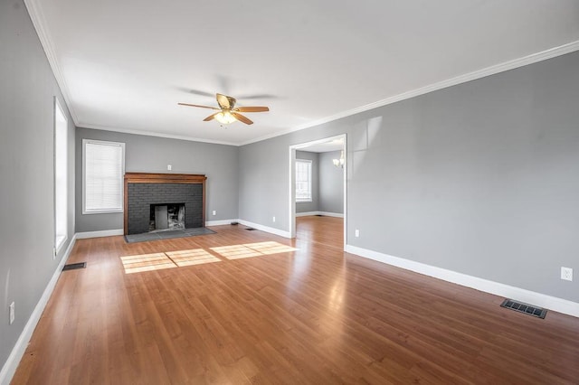 unfurnished living room with baseboards, visible vents, wood finished floors, and ceiling fan with notable chandelier