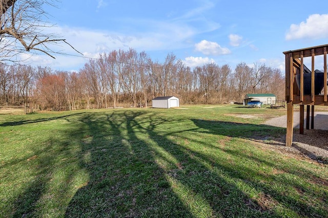 view of yard featuring an outbuilding, dirt driveway, and a shed