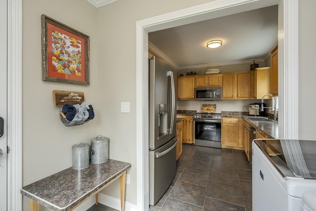 kitchen featuring ornamental molding, appliances with stainless steel finishes, dark countertops, and a sink