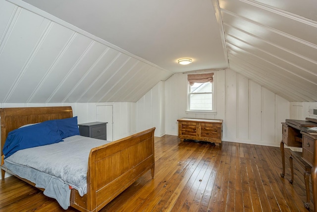 bedroom featuring vaulted ceiling and wood-type flooring