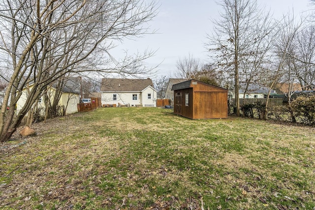 view of yard featuring fence private yard, an outdoor structure, and a shed