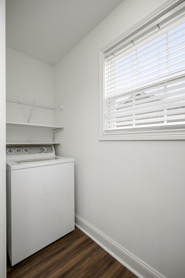 clothes washing area featuring laundry area, washer / clothes dryer, dark wood-style flooring, and baseboards