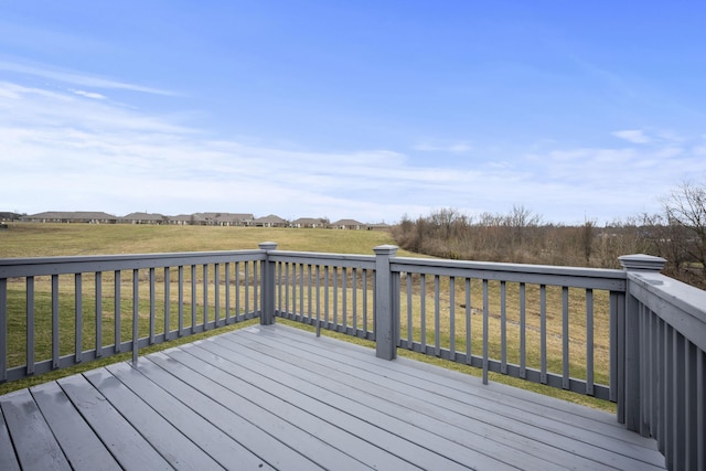 wooden terrace featuring a lawn