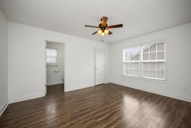 unfurnished bedroom featuring ceiling fan, baseboards, and dark wood-type flooring