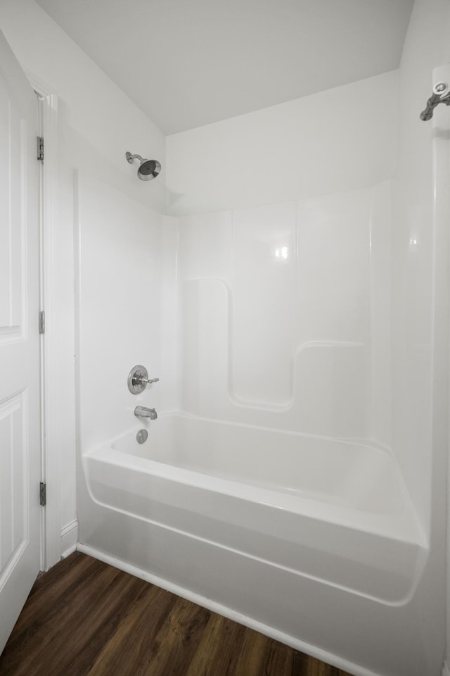 full bath with tub / shower combination and wood finished floors