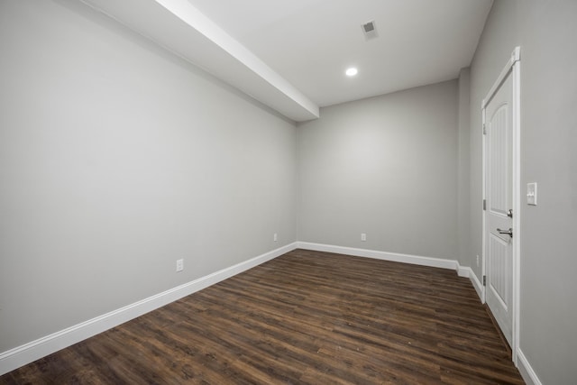 unfurnished room with dark wood-style flooring, recessed lighting, visible vents, and baseboards