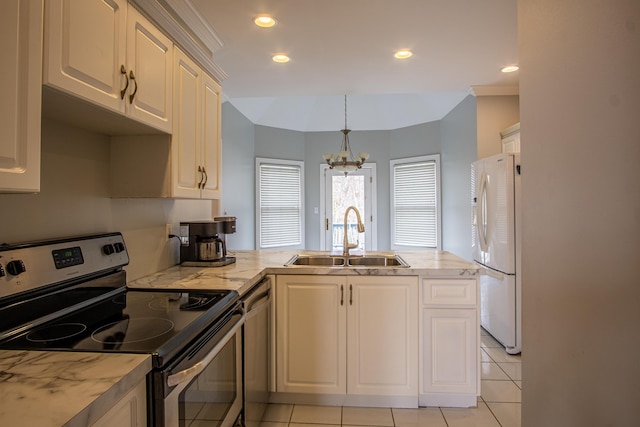 kitchen with recessed lighting, a peninsula, a sink, hanging light fixtures, and appliances with stainless steel finishes