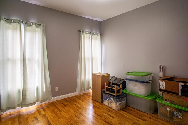 interior space featuring baseboards and wood finished floors