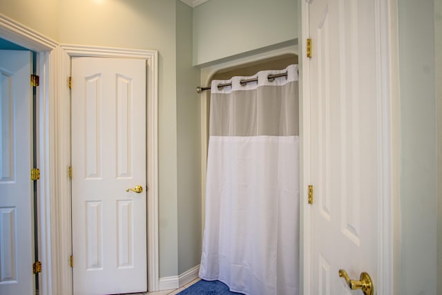 full bath with baseboards and a shower with shower curtain