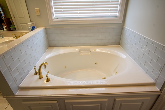 full bathroom featuring a sink and a jetted tub