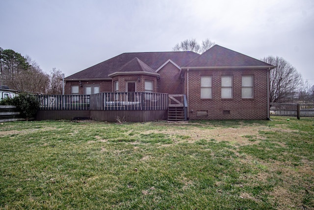 view of front of property featuring brick siding, a shingled roof, crawl space, a deck, and a front lawn