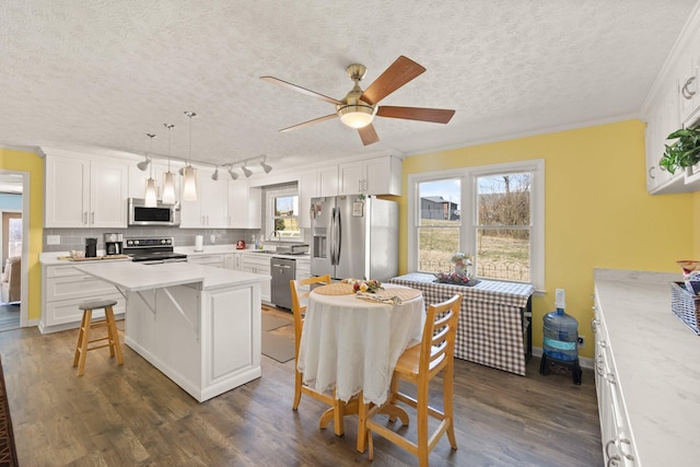 kitchen featuring dark wood-style floors, stainless steel appliances, tasteful backsplash, light countertops, and white cabinets