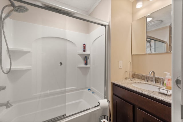 bathroom featuring combined bath / shower with glass door and vanity