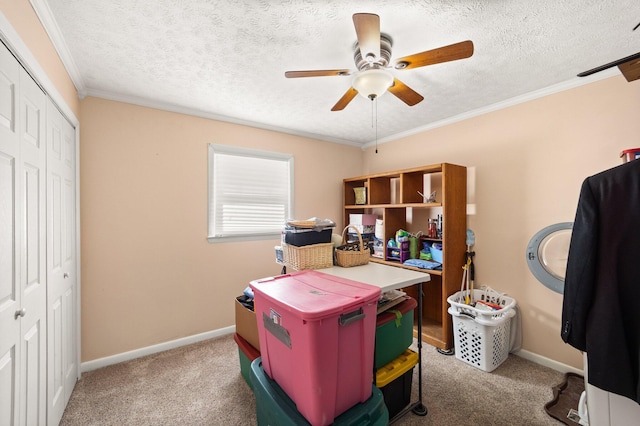 office space with ceiling fan, a textured ceiling, baseboards, carpet, and crown molding