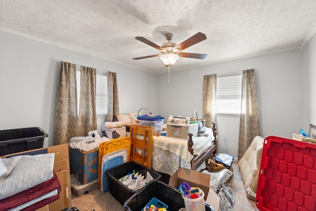 bedroom featuring a textured ceiling, ornamental molding, carpet, and a ceiling fan