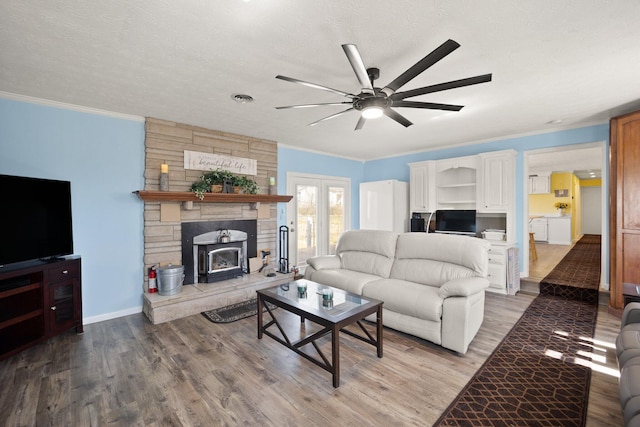 living room featuring ornamental molding, light wood-type flooring, and visible vents