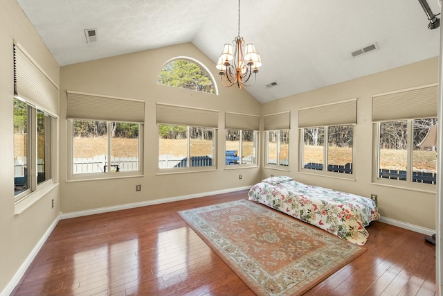 bedroom with baseboards, visible vents, and hardwood / wood-style floors