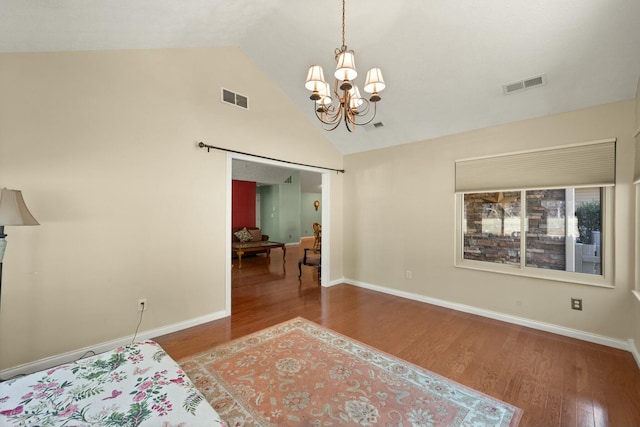 bedroom with an inviting chandelier, baseboards, visible vents, and wood finished floors