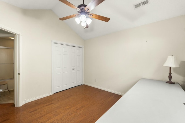 bedroom featuring lofted ceiling, baseboards, visible vents, and wood finished floors