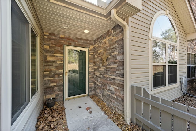 entrance to property featuring stone siding