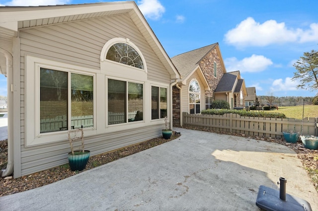 rear view of property with a patio and fence