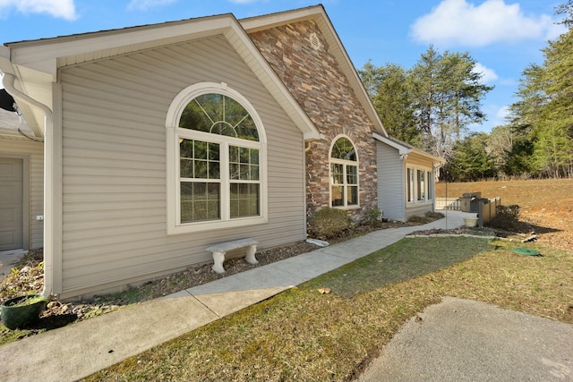 view of side of home with brick siding