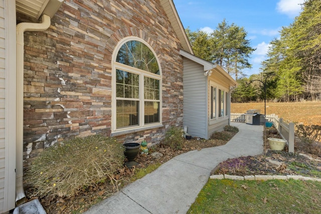 view of side of property with stone siding