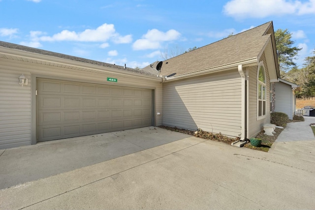 garage with concrete driveway