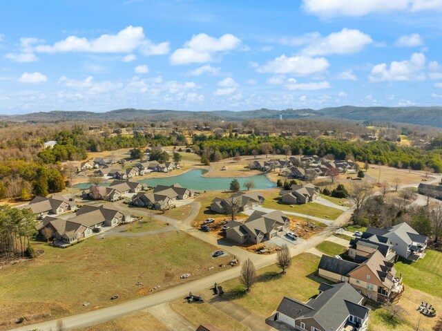 drone / aerial view featuring a residential view and a water and mountain view